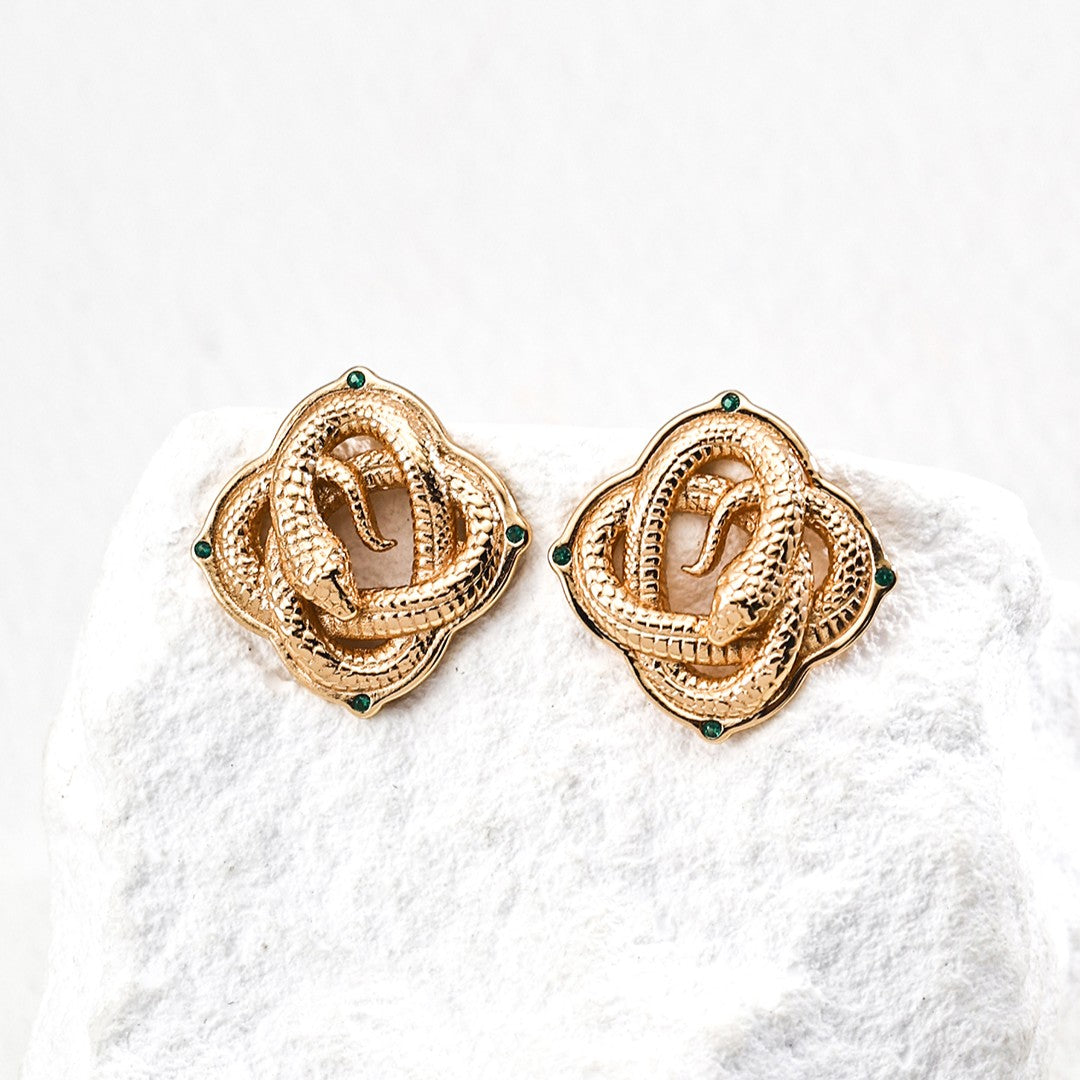 Close-up of ear wearing a gold hoop earring with hammered texture and dangling white pearl from Chanqinfang jewelry