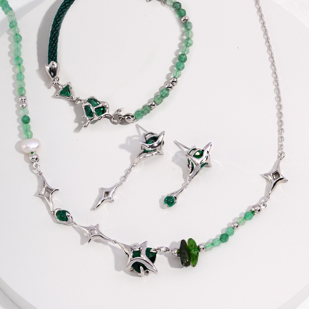 Silver and green gemstone jewelry set with necklace, bracelet, and matching earrings on white background