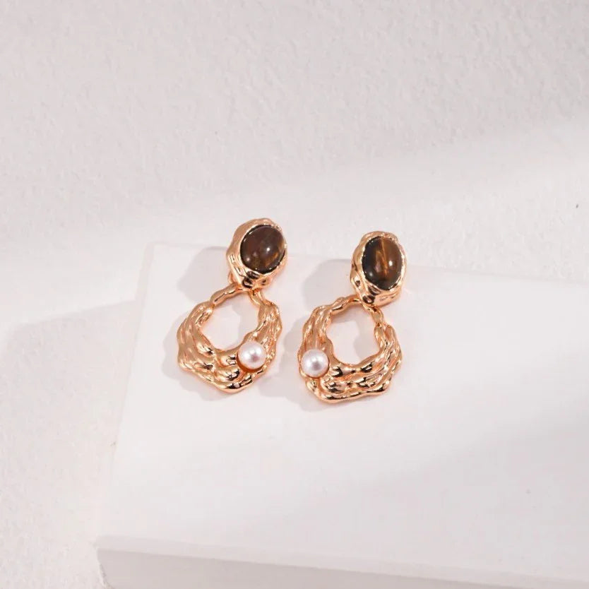 Elegant gold-tone earrings with brown stone tops and textured hoops adorned with small pearls